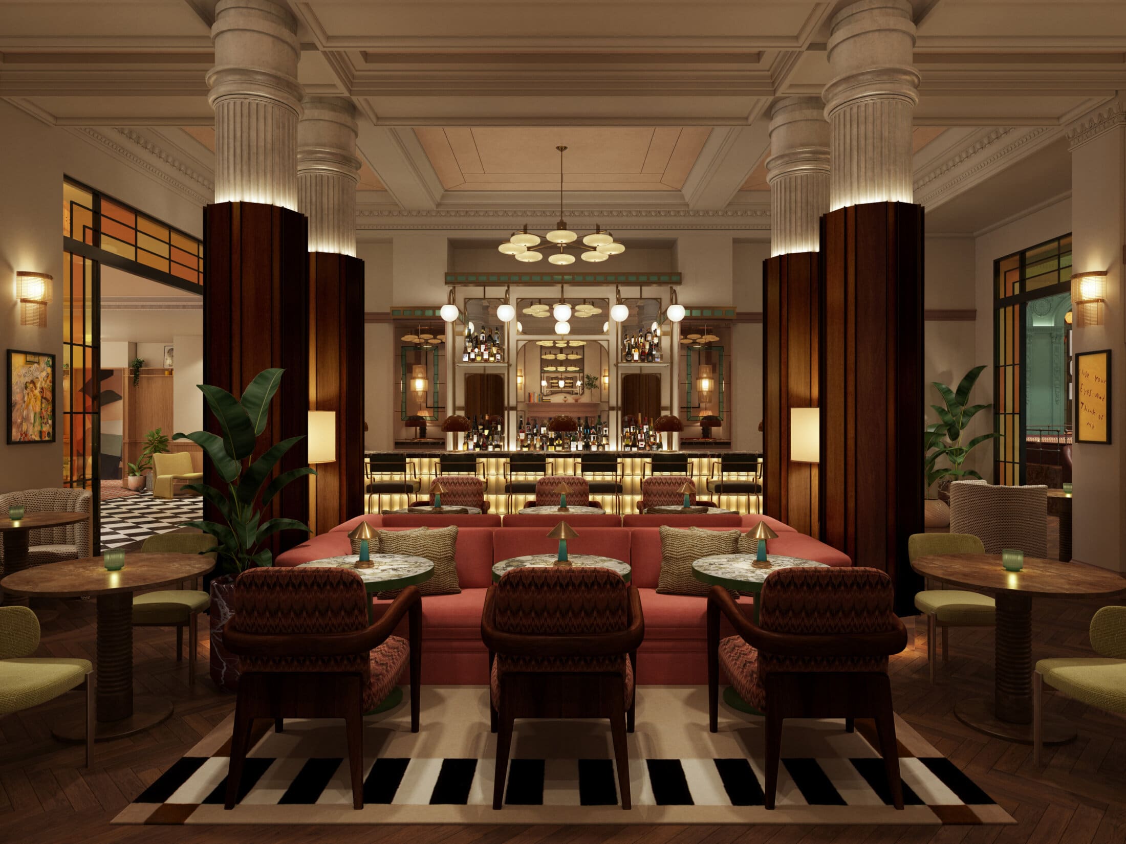 A stylish, upscale lounge at The Webster features plush pink sofas, round tables, patterned chairs, and tall columns. Warm lighting highlights the elegant bar at the back, with plants and modern decor throughout the space.